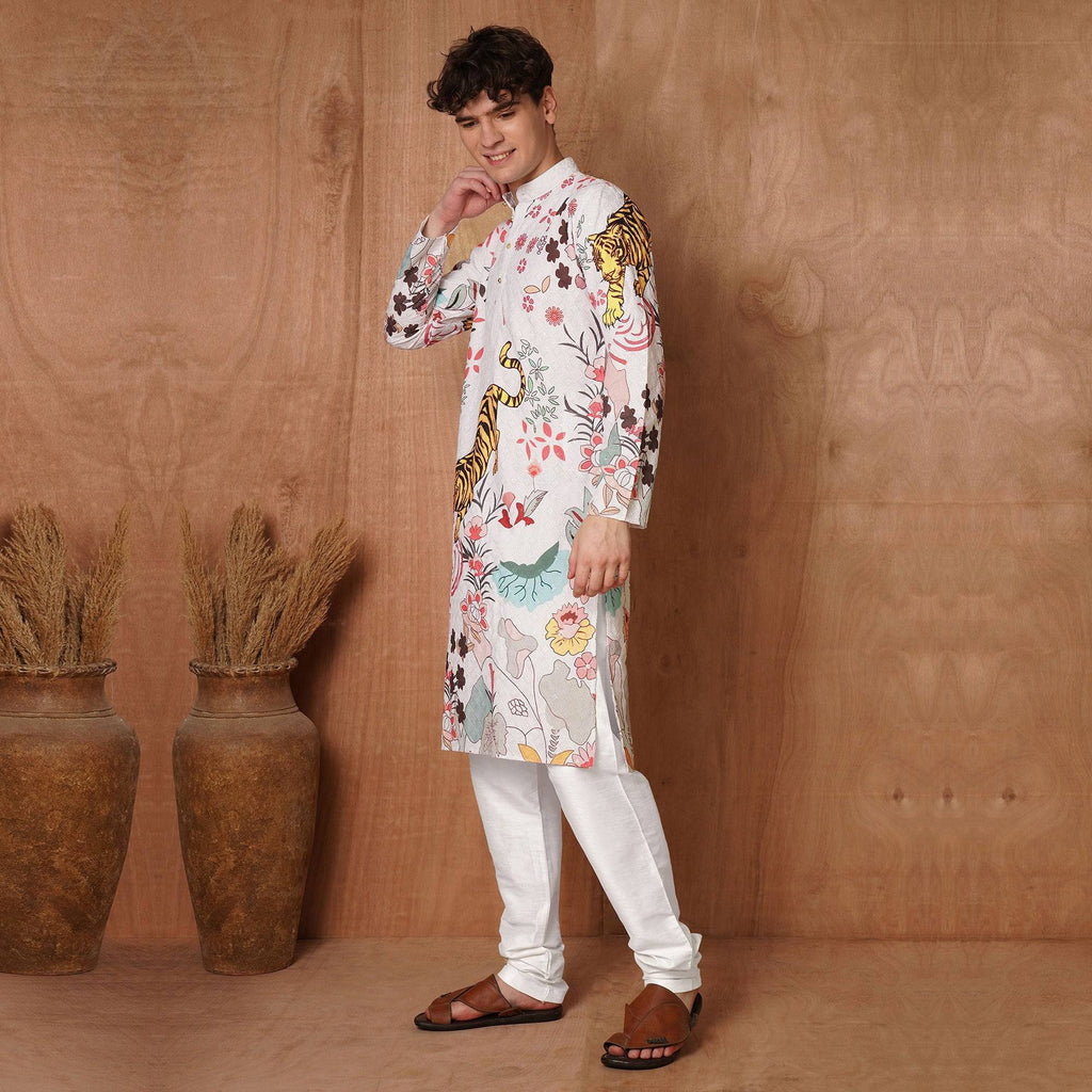 Stylish men's white Chikankari kurta with tiger and floral motifs, paired with white churidar for a complete ethnic look.
