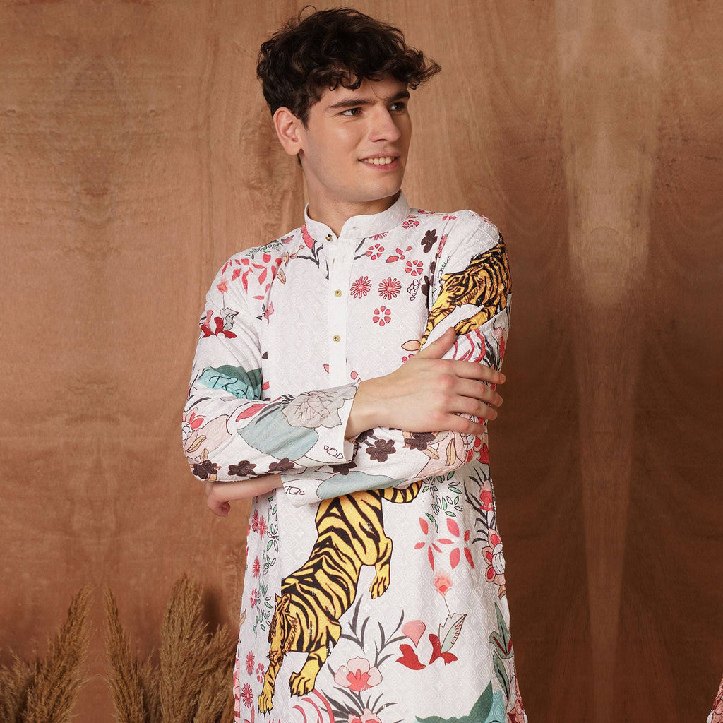 Men's white designer kurta with bold tiger and floral print in Chikankari fabric, ideal festive wear for weddings and cultural events.