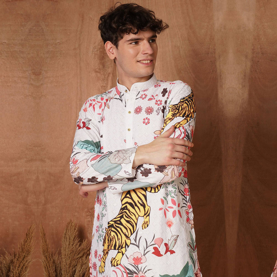 Men's white designer kurta with bold tiger and floral print in Chikankari fabric, ideal festive wear for weddings and cultural events.
