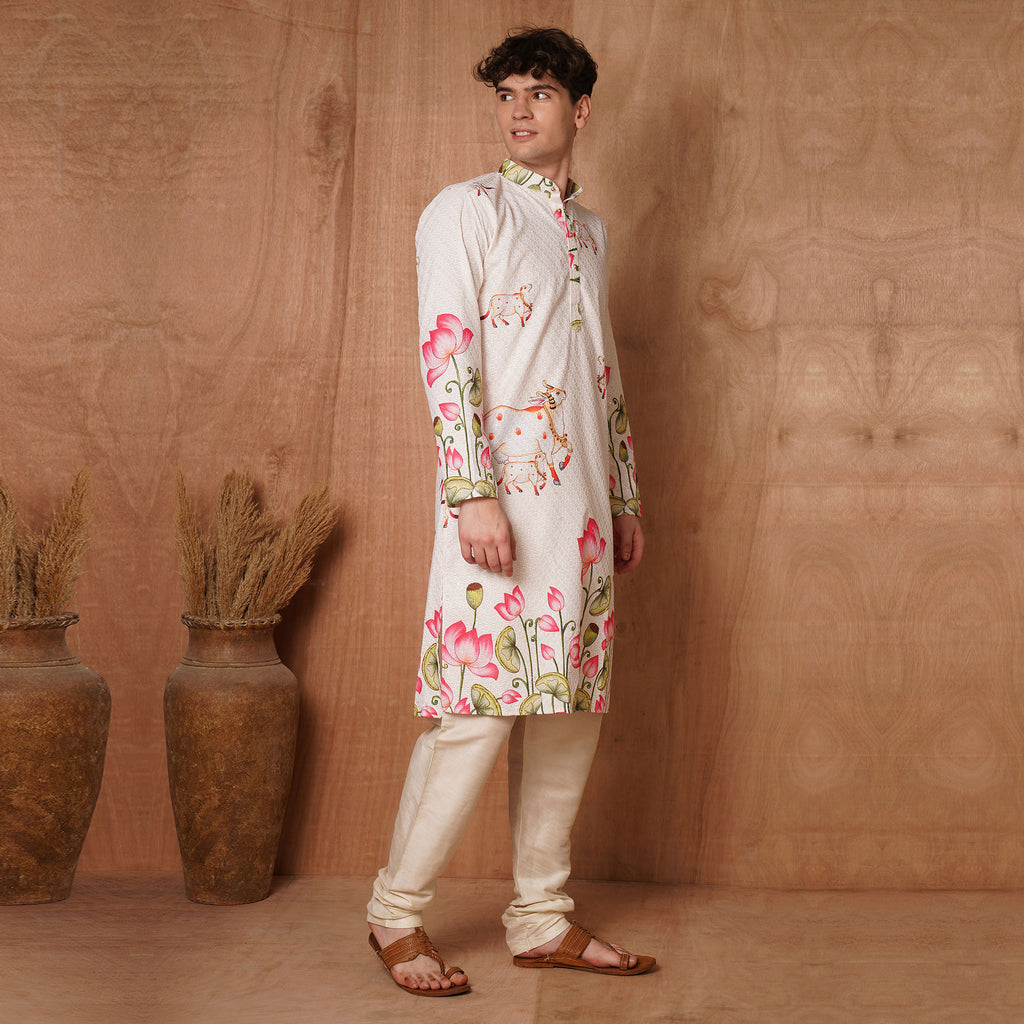 Side profile of men's Chikankari Kurta in cream with divine cow and lotus motifs, paired with beige churidar for ethnic elegance.