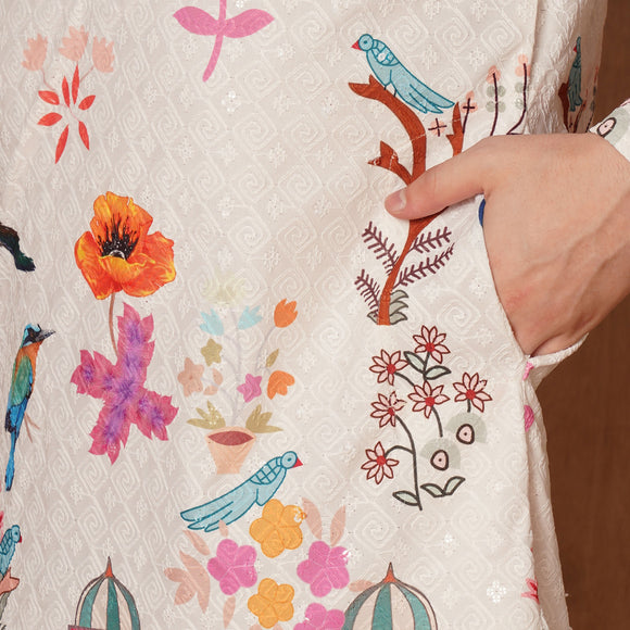 Close-up of cream Chikankari cotton kurta showcasing intricate Mughal floral and bird print with pocket detail.