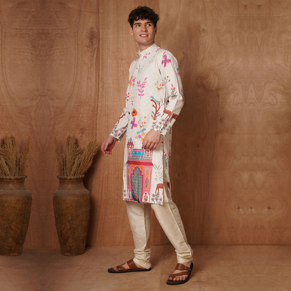 Model walking in cream Chikankari kurta with multicolor Mughal print, styled with beige churidar and sandals.