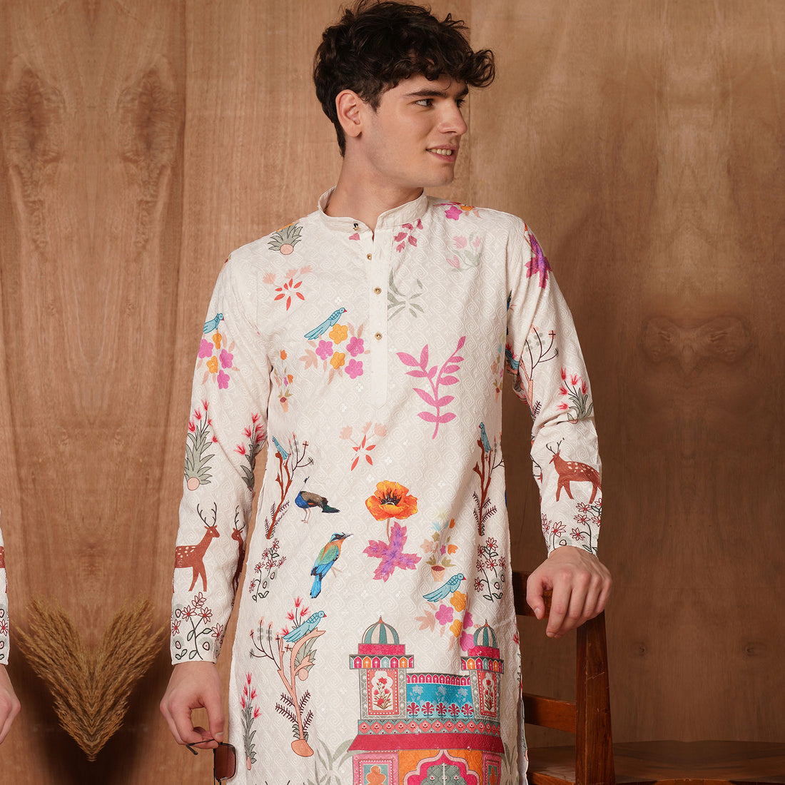 Upper body close-up of cream Chikankari kurta with multicolor Mughal floral and bird motifs, showcasing ethnic elegance.