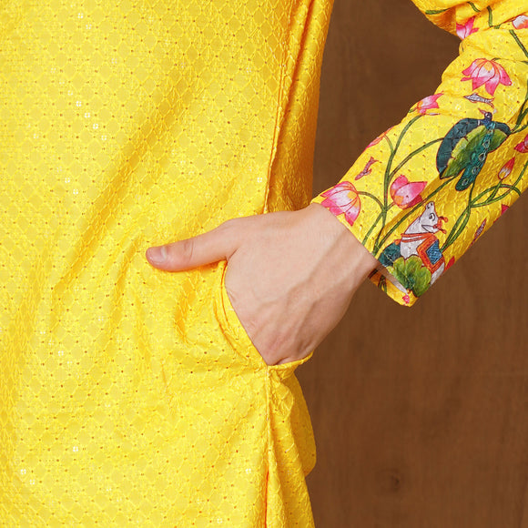 Close-up of Men’s Yellow Floral Kurta pocket detail showing intricate floral and peacock print on bright yellow fabric.