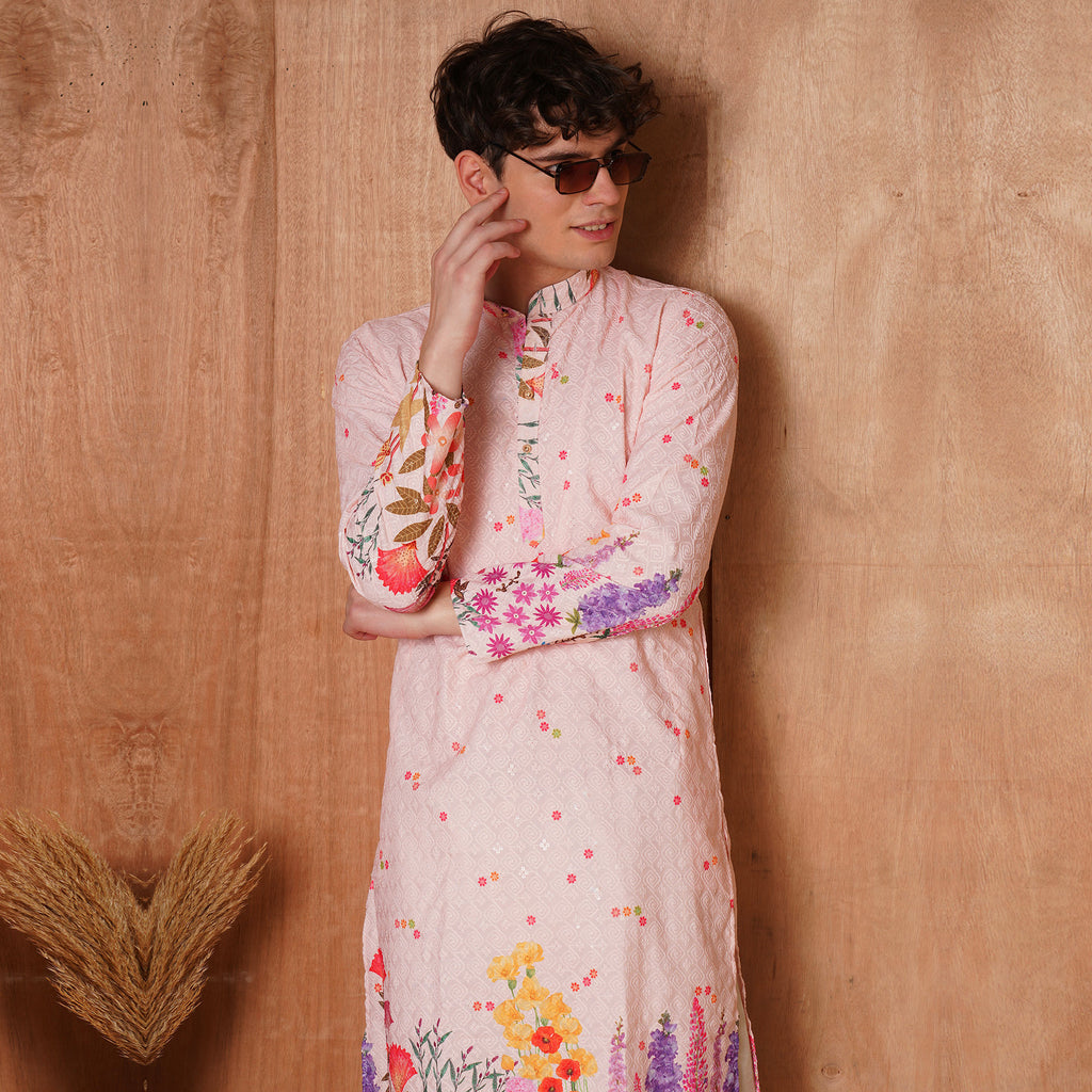 Men’s Ethnic Pink Chikankari Kurta with vibrant botanical print, styled for festive wear. Features full sleeves and floral detailing on cuffs.