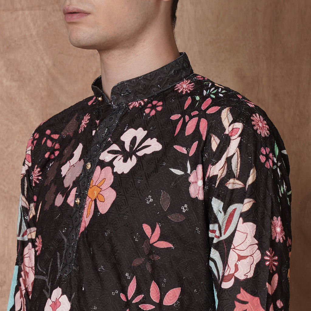 Detailed close-up of collar and floral print on men’s black kurta, highlighting intricate ethnic design for festive occasions.