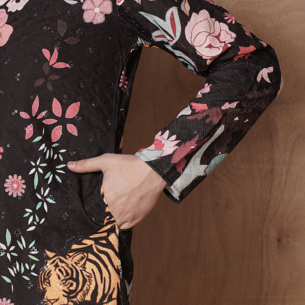 Close-up of sleeve and pocket area on men’s black kurta with tiger and floral print, emphasizing festive ethnic craftsmanship.