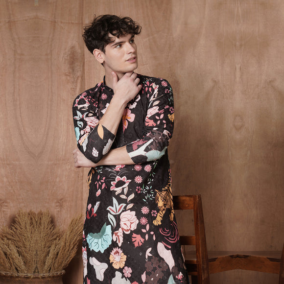 Close-up of men’s black designer kurta featuring vibrant floral and tiger motifs, ideal for ethnic celebrations and parties.