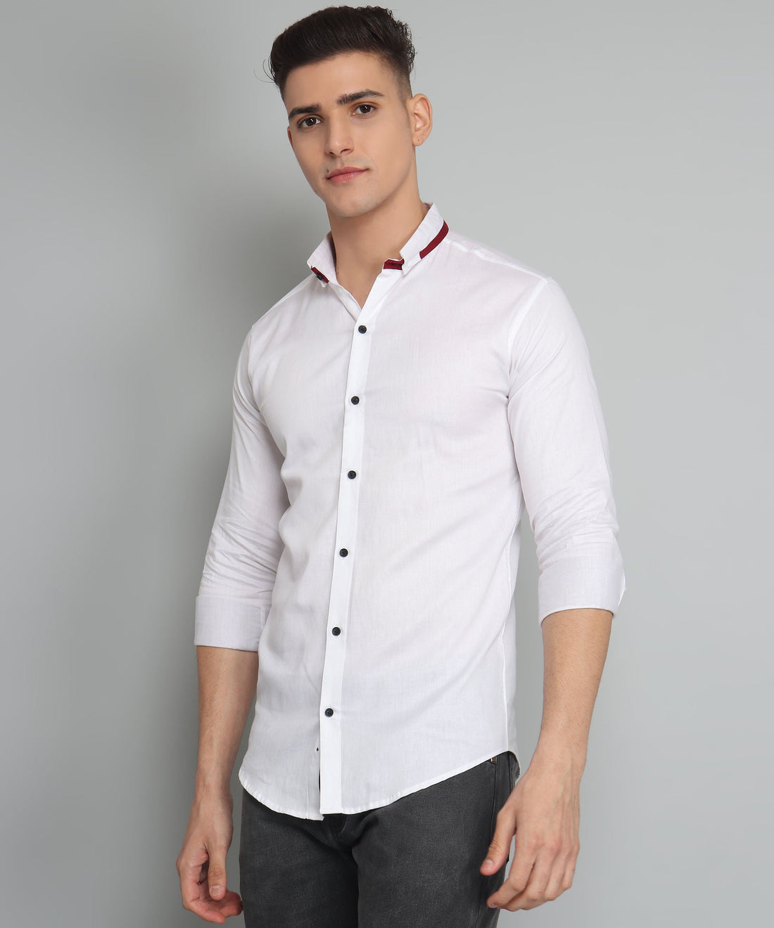 
a man wearing a white shirt and black pants
