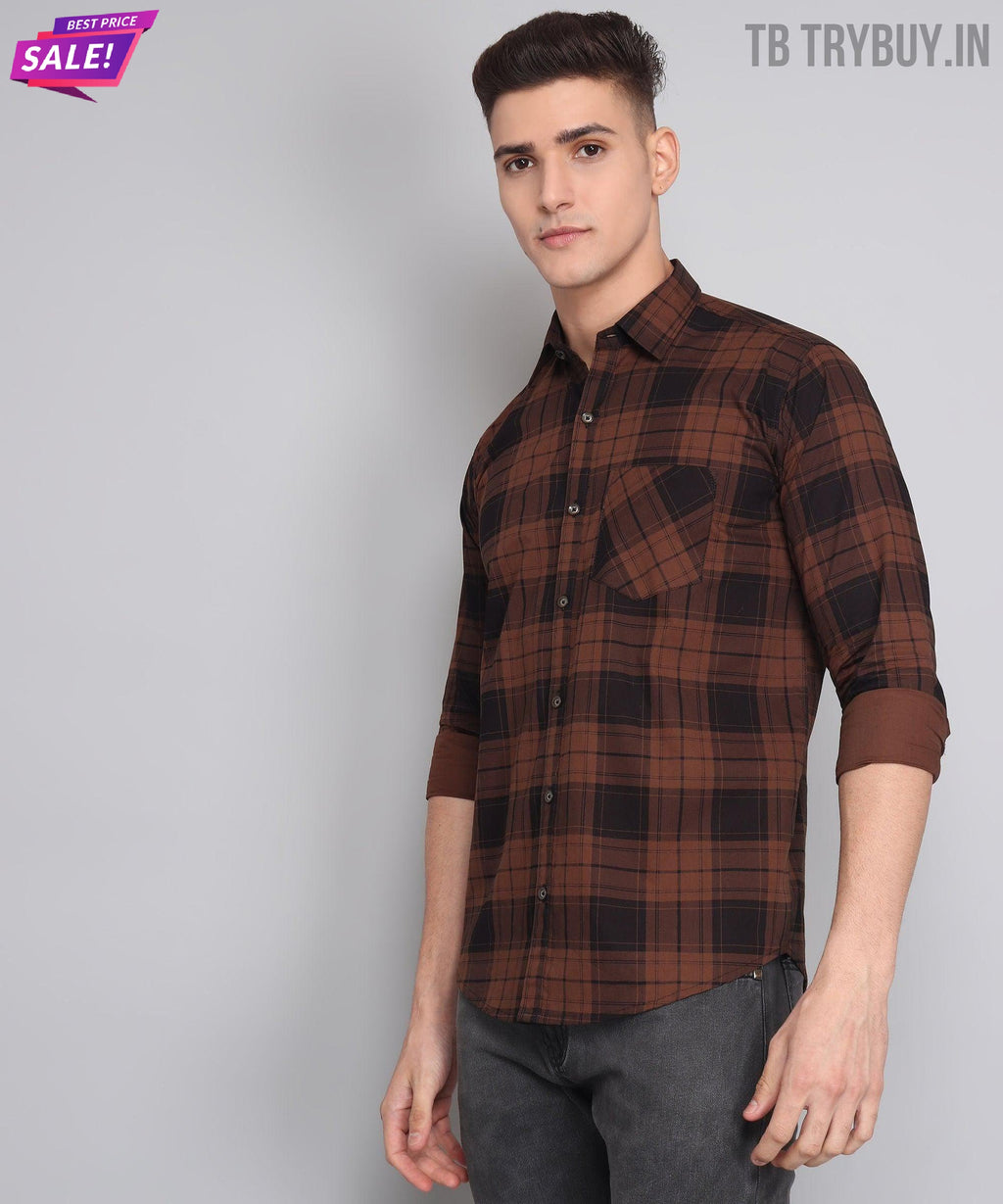 a young man wearing a brown and black plaid shirt