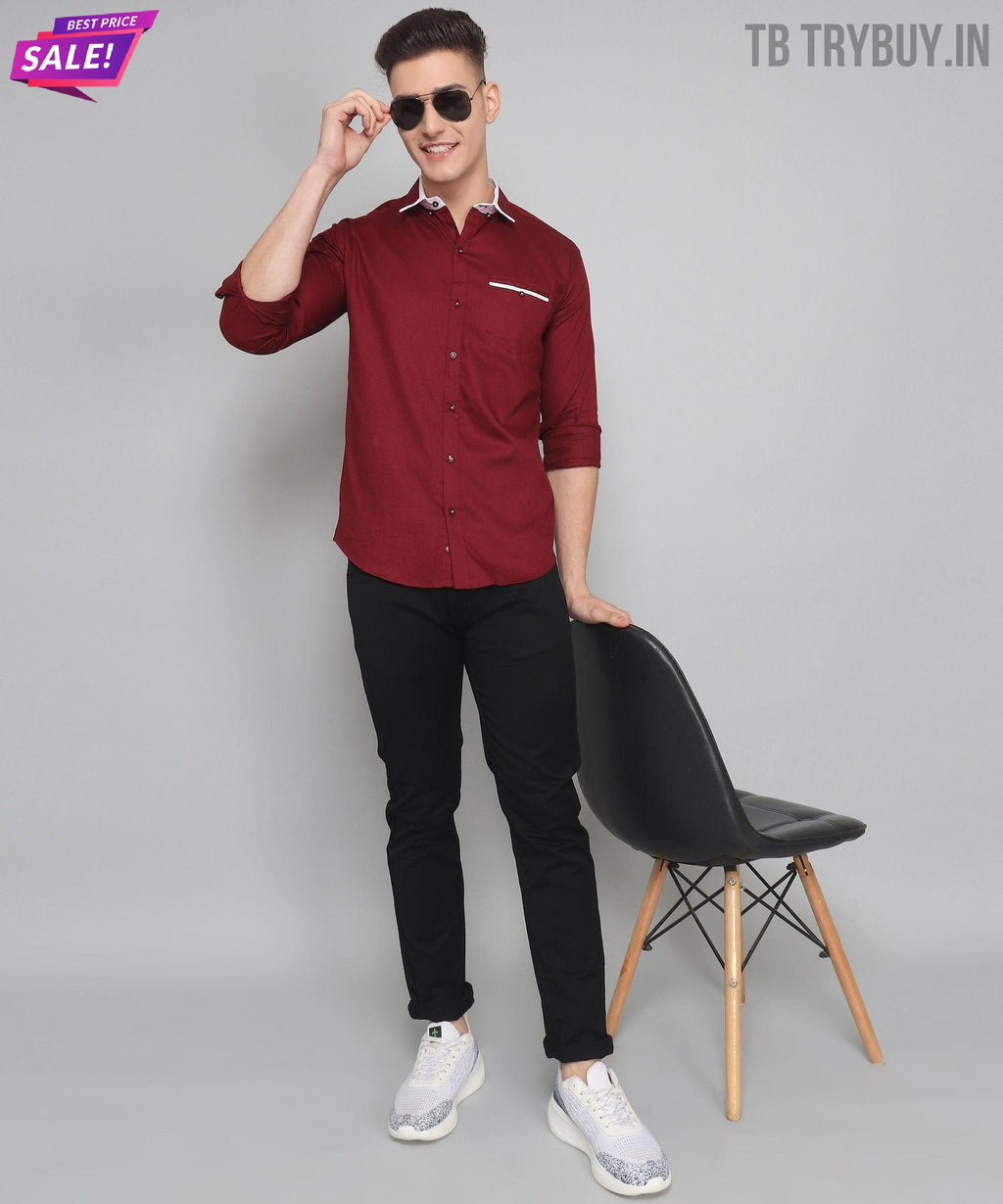 a man standing next to a chair wearing sunglasses