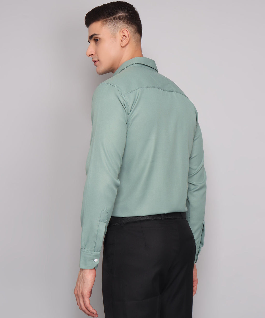 a man in a green shirt and black pants