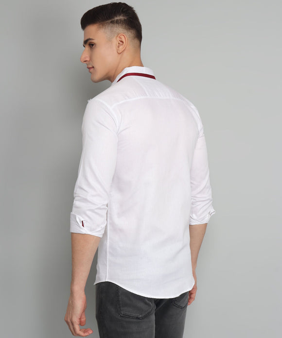 a man wearing a white shirt and black pants