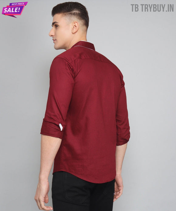 a man wearing a red shirt and black pants