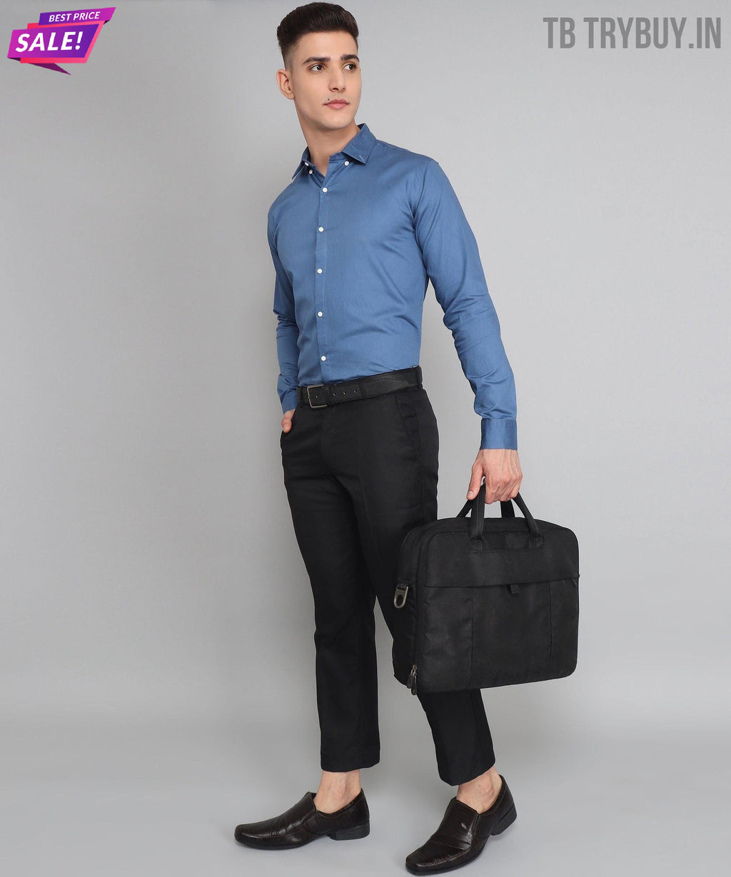 a man in a blue shirt is holding a black bag