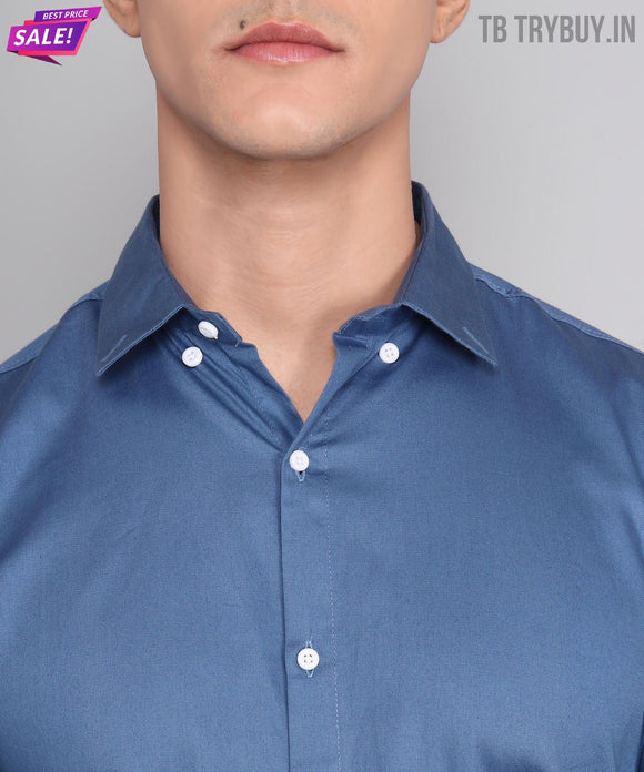 a man wearing a blue shirt and a pair of glasses