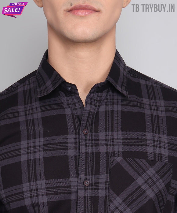 a man wearing a black and grey plaid shirt