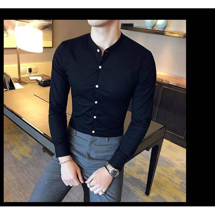 a man wearing a black shirt and grey pants