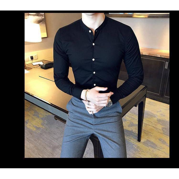 a man wearing a black shirt and grey pants