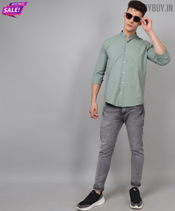 a man in a green shirt and grey pants