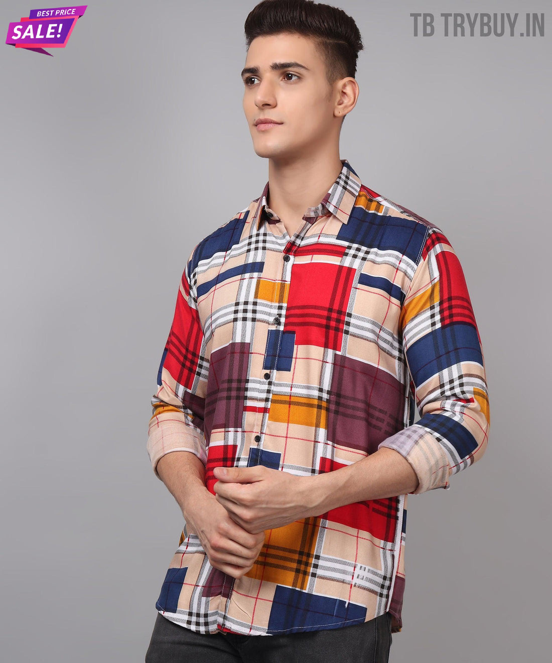 a young man wearing a multicolored plaid shirt