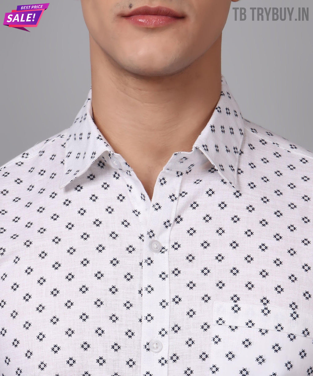 a man wearing a white shirt with black crosses on it