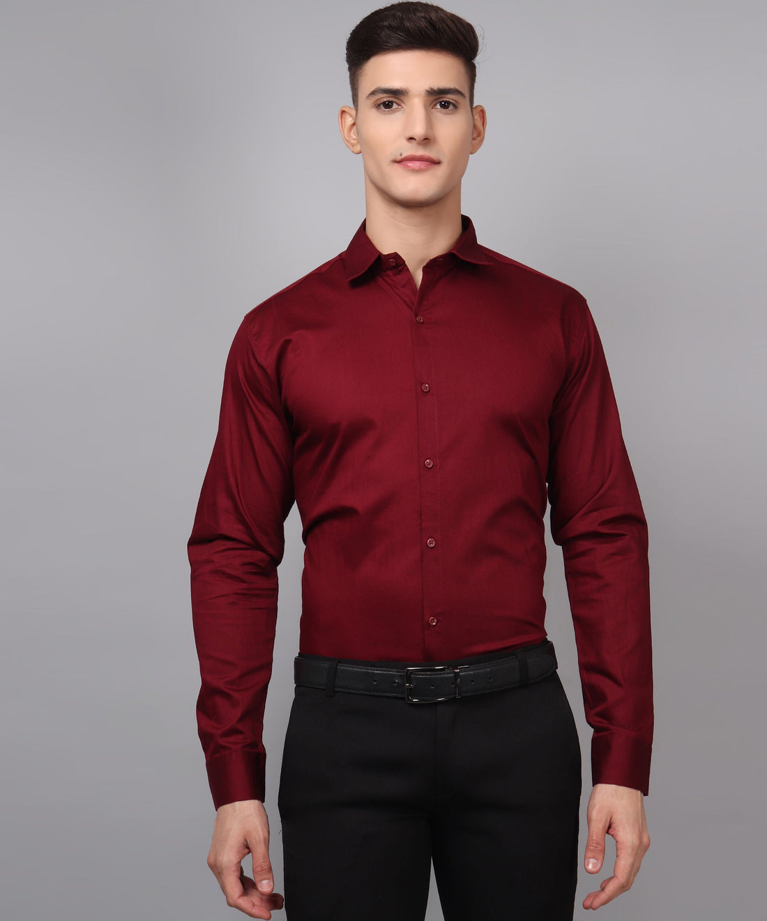 a man wearing a red shirt and black pants