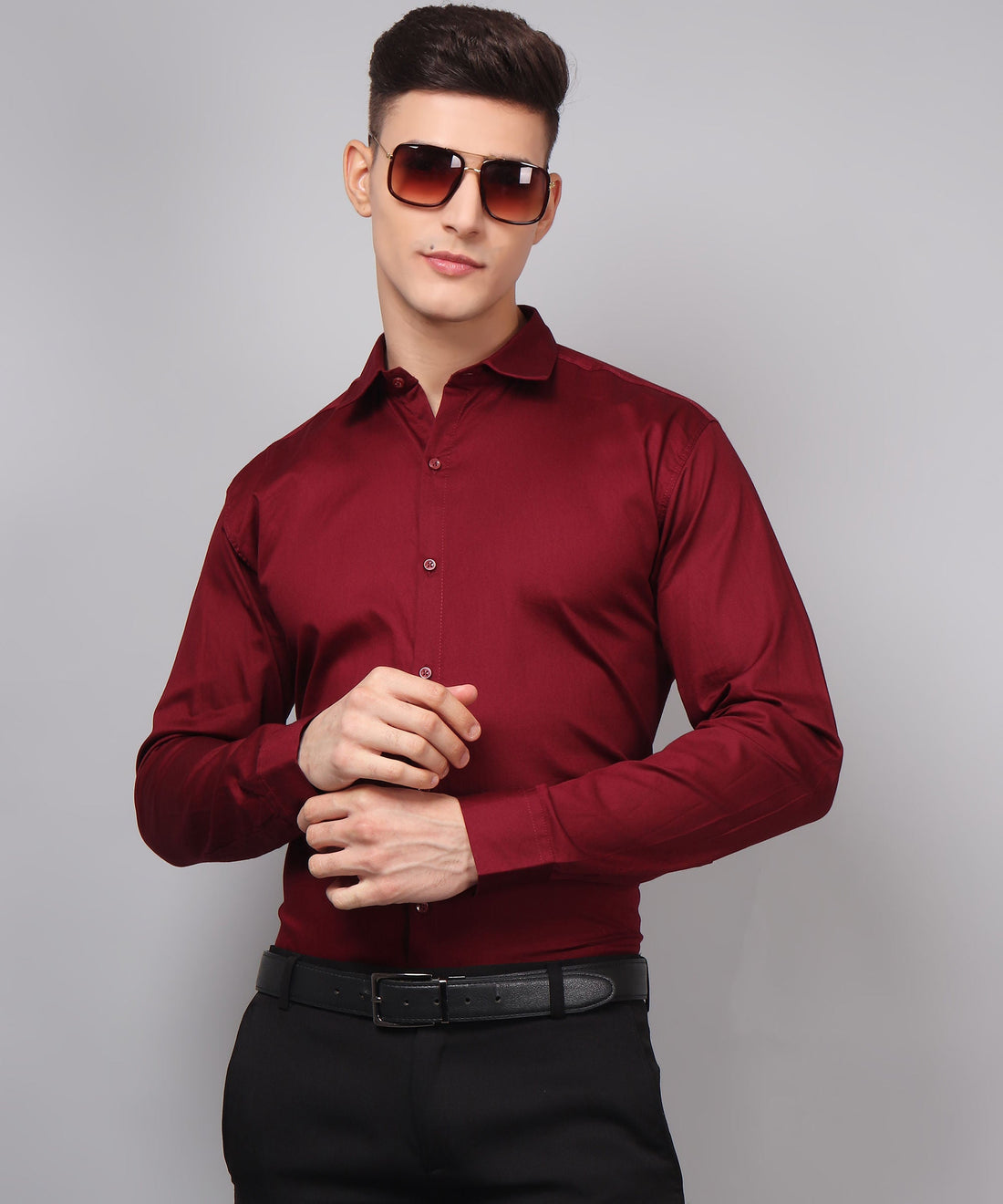 a man wearing a red shirt and black pants