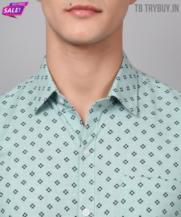 a man wearing a green shirt with a black and white pattern