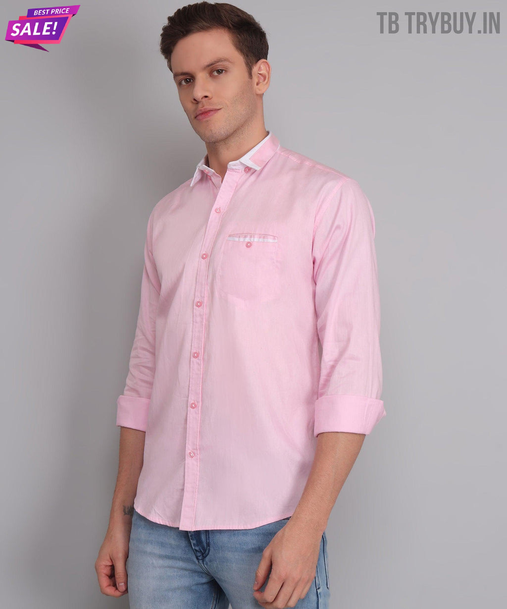 a man wearing a pink shirt and jeans