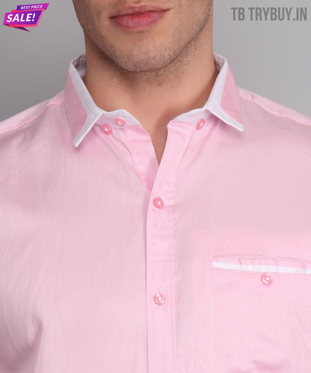 a close up of a man wearing a pink shirt