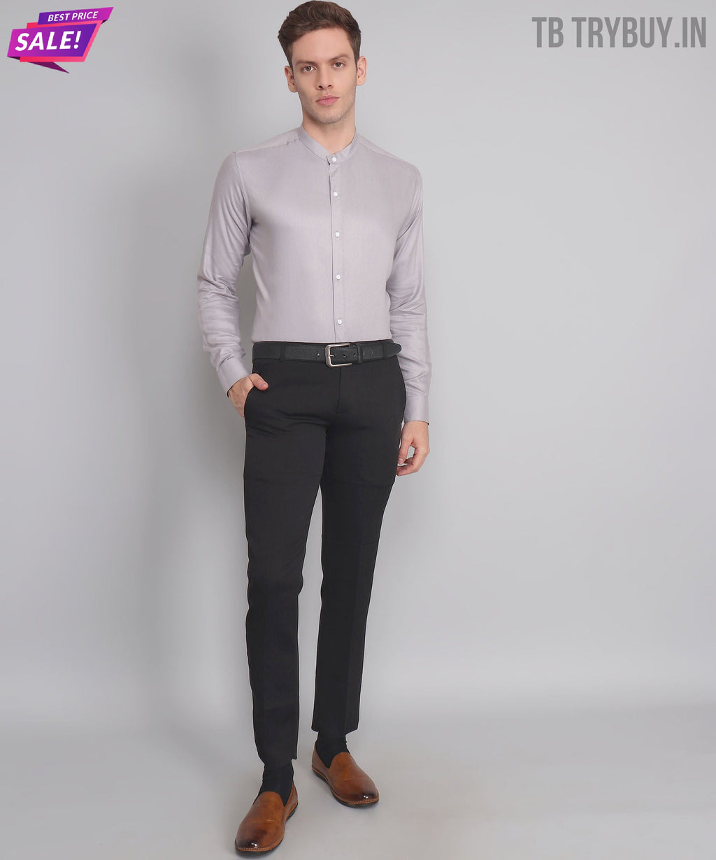 a man in a gray shirt and black pants