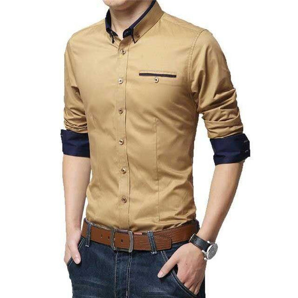 a man wearing a tan shirt and jeans