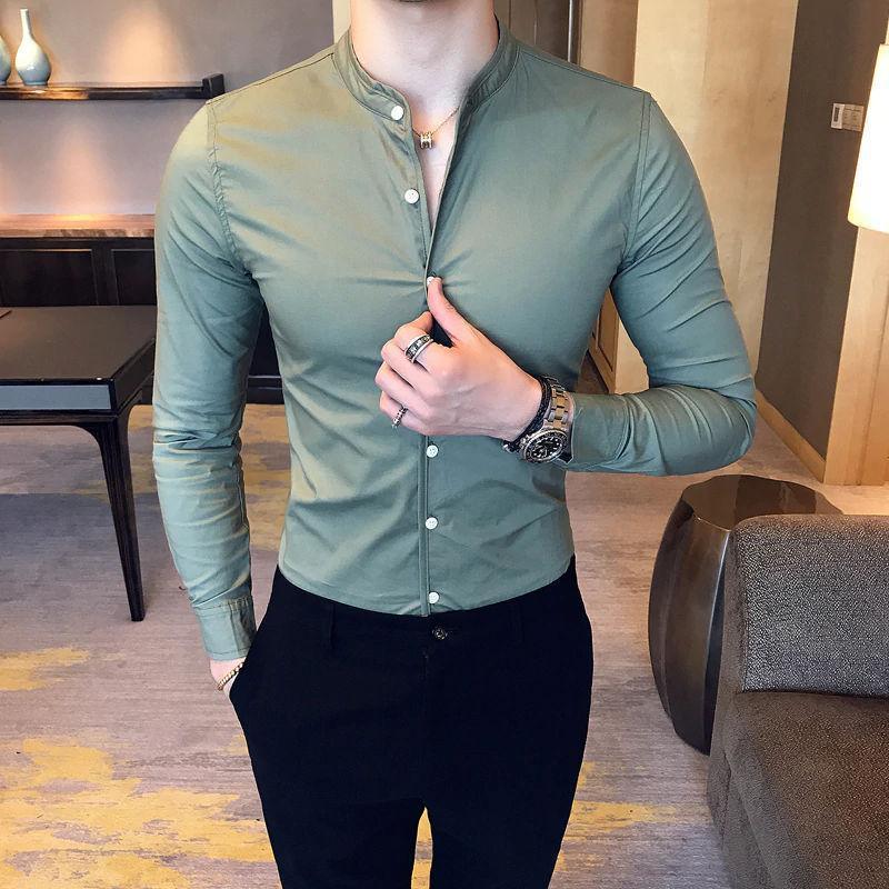 a man wearing a green shirt and black pants