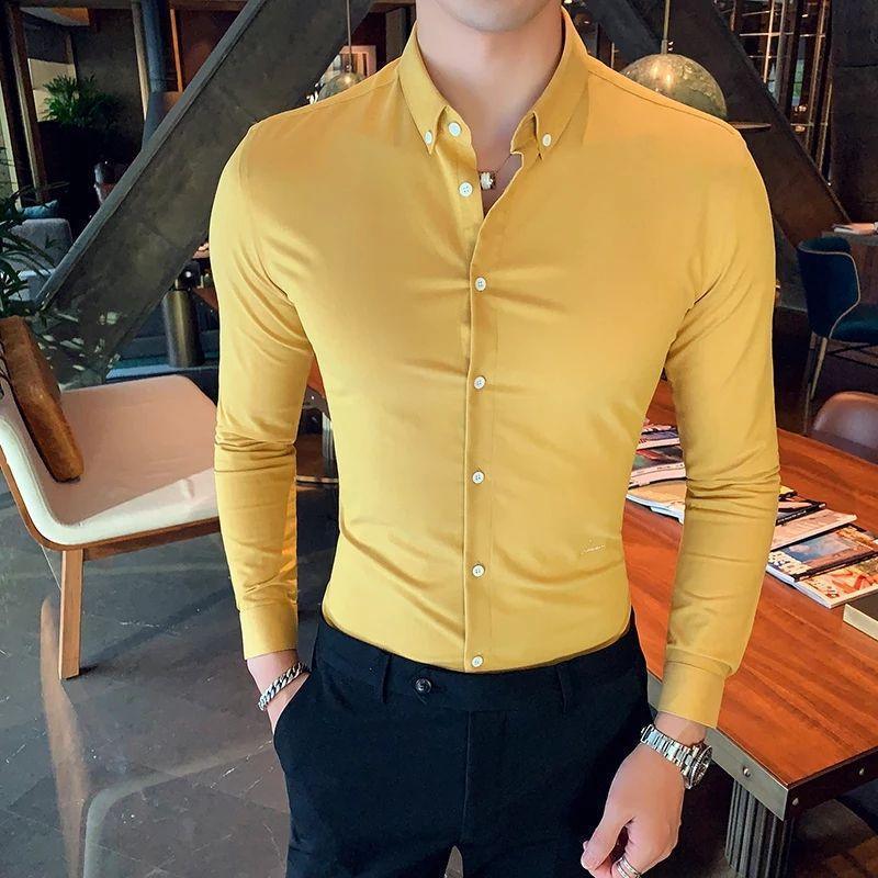 a man wearing a yellow shirt and black pants