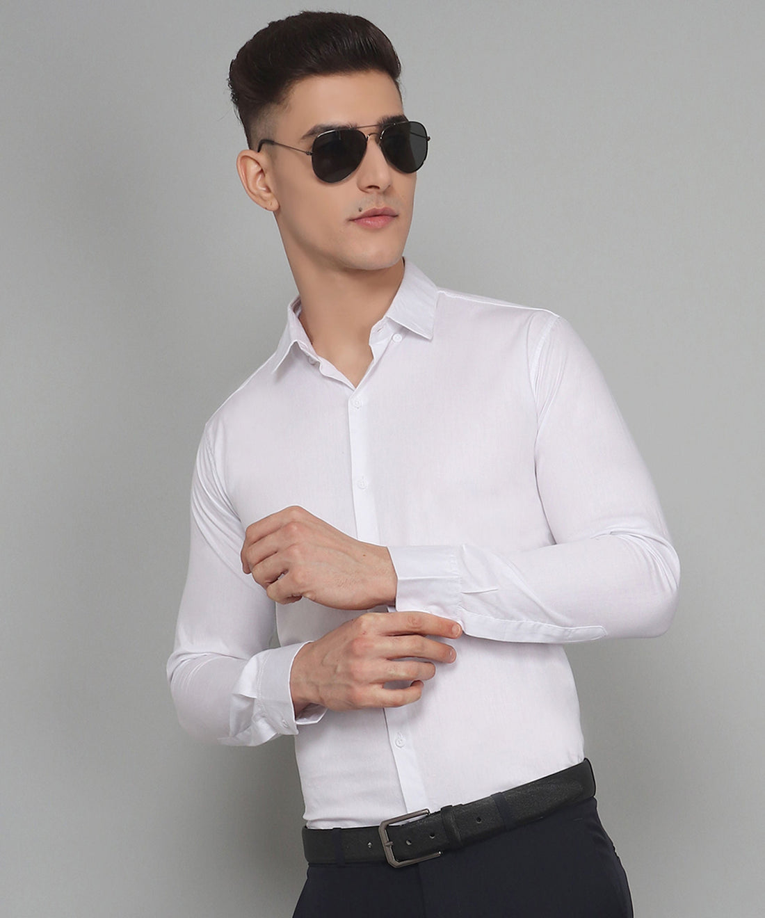 
a man wearing a white shirt and black pants
