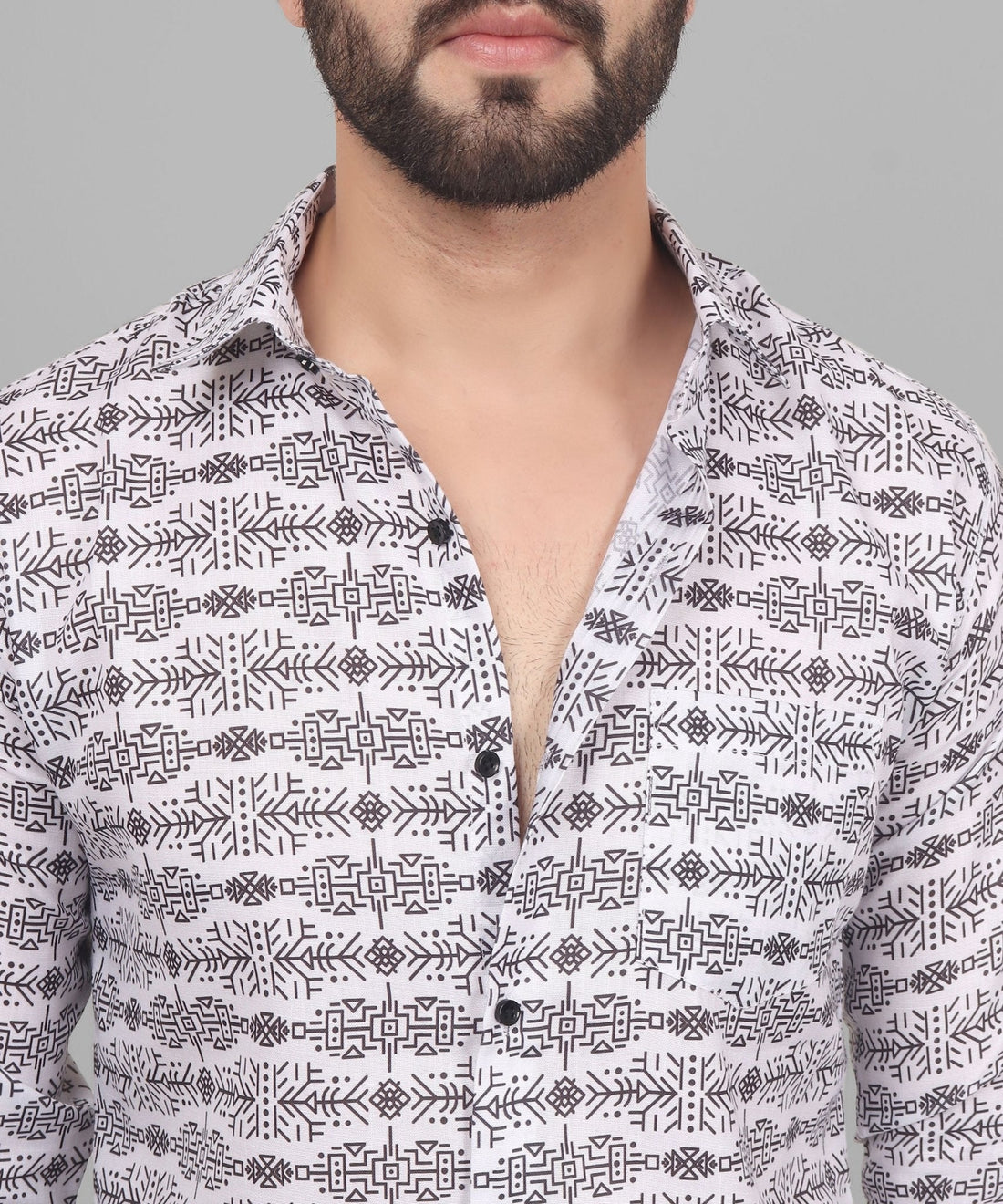 
a man with a beard wearing a white shirt
