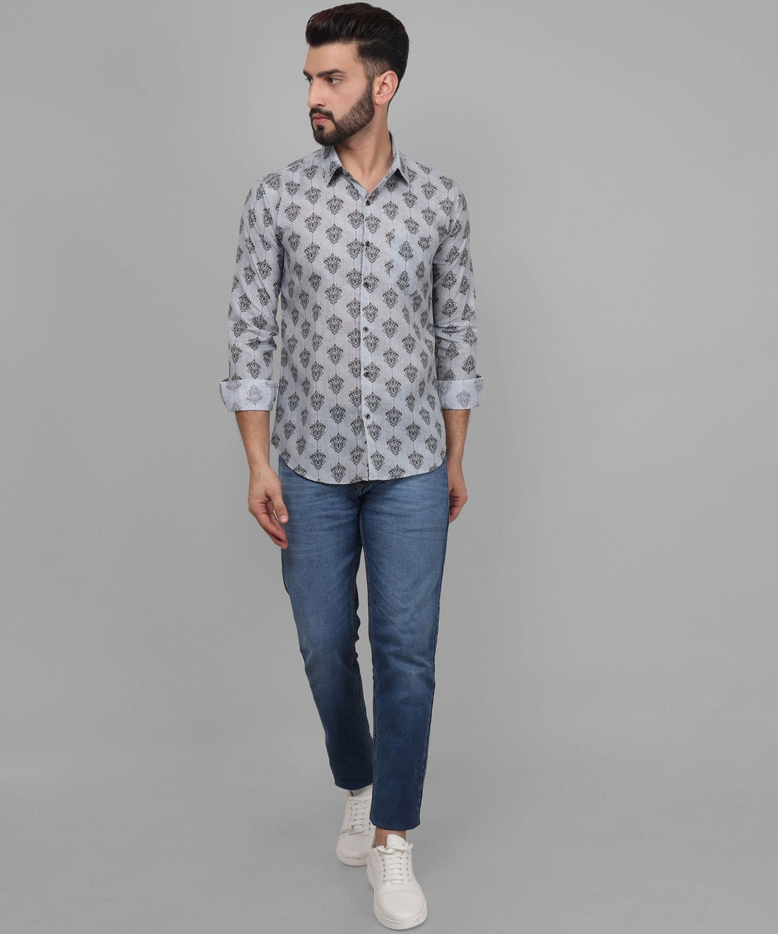 
a man wearing a grey shirt and jeans
