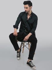 a man sitting on top of a wooden chair