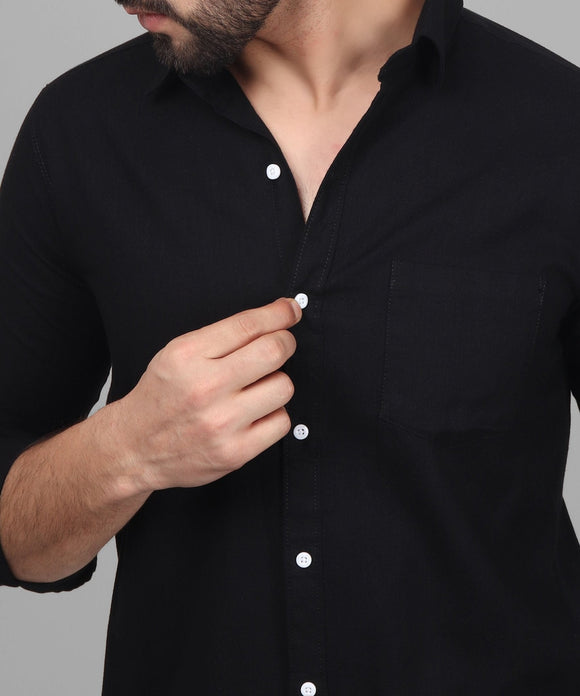 a man wearing a black shirt with white buttons