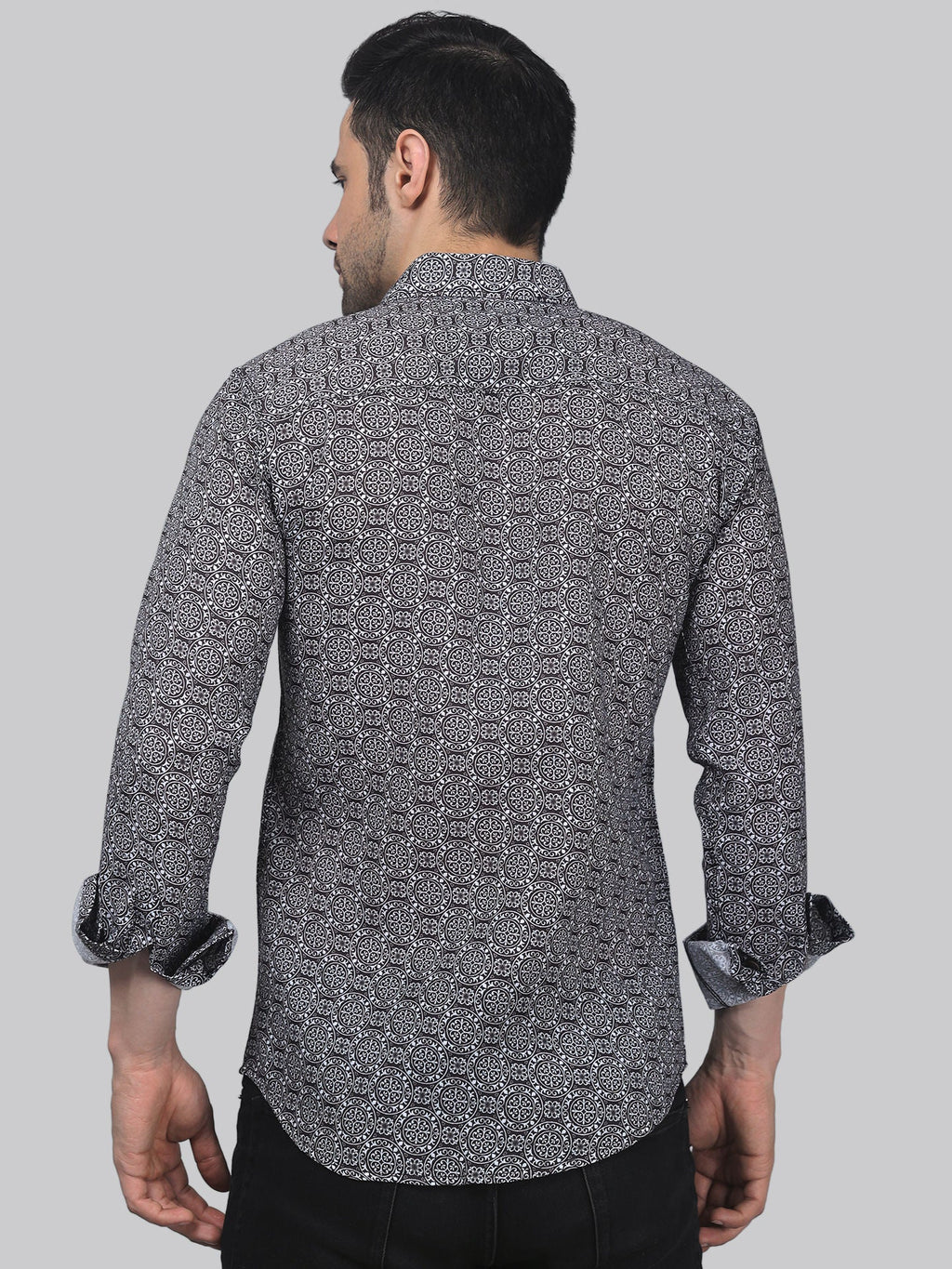 a man wearing a black and white patterned shirt