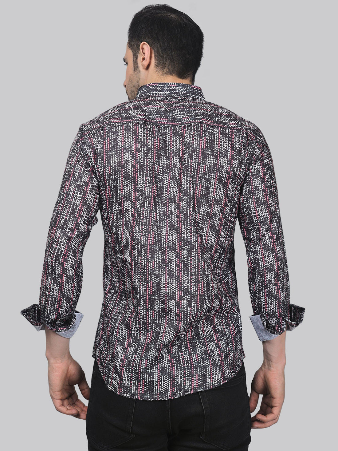
a man wearing a black and red patterned shirt
